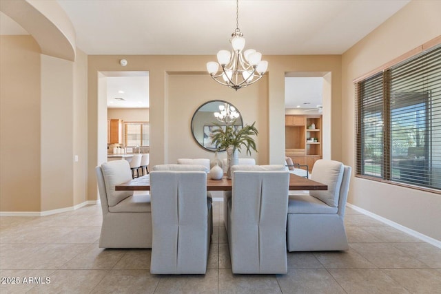 12820 W La Vina Dr, Sun City West, AZ 85375 - dining area with tile patterned floors, baseboards, and a notable chandelier
