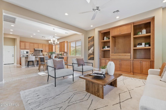 12820 W La Vina Dr, Sun City West, AZ 85375 - living area with ceiling fan with notable chandelier, visible vents, and recessed lighting