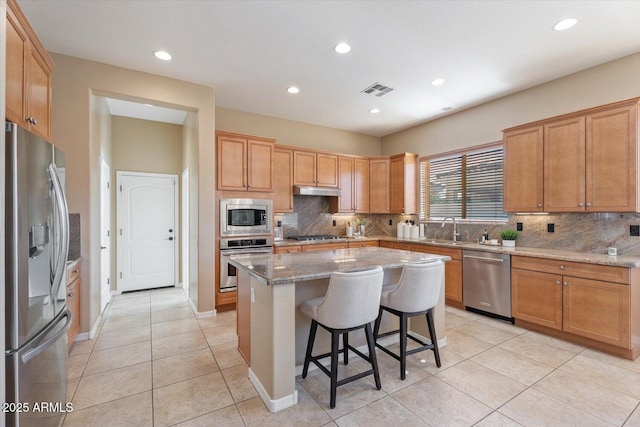 12820 W La Vina Dr, Sun City West, AZ 85375 - kitchen featuring a sink, visible vents, decorative backsplash, appliances with stainless steel finishes, and light tile patterned floors