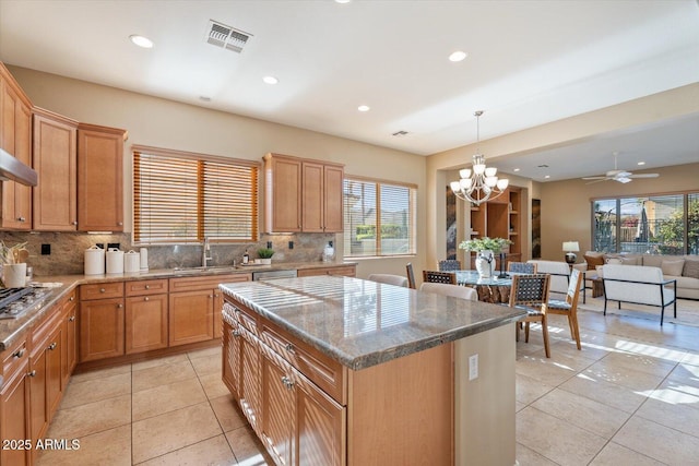 12820 W La Vina Dr, Sun City West, AZ 85375 - kitchen featuring a center island, a sink, backsplash, and light tile patterned floors