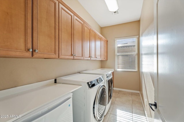 12820 W La Vina Dr, Sun City West, AZ 85375 - clothes washing area with washer and dryer, baseboards, cabinet space, and light tile patterned floors