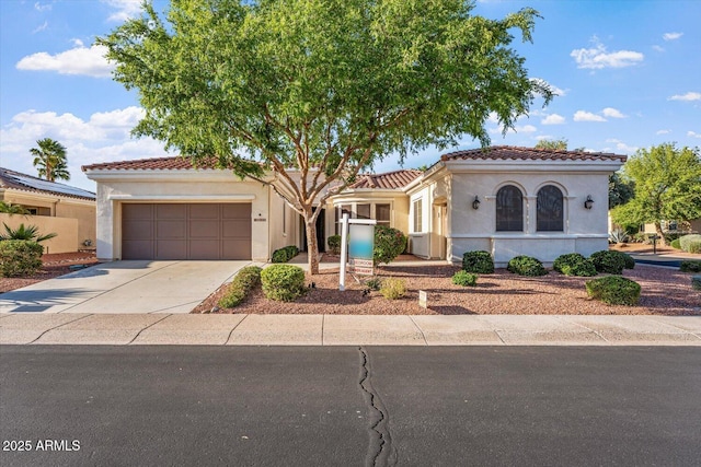 12820 W La Vina Dr, Sun City West, AZ 85375 - mediterranean / spanish house featuring a garage, driveway, a tiled roof, and stucco siding
