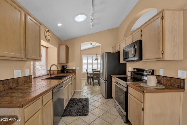 kitchen featuring light brown cabinets, track lighting, sink, appliances with stainless steel finishes, and tile counters