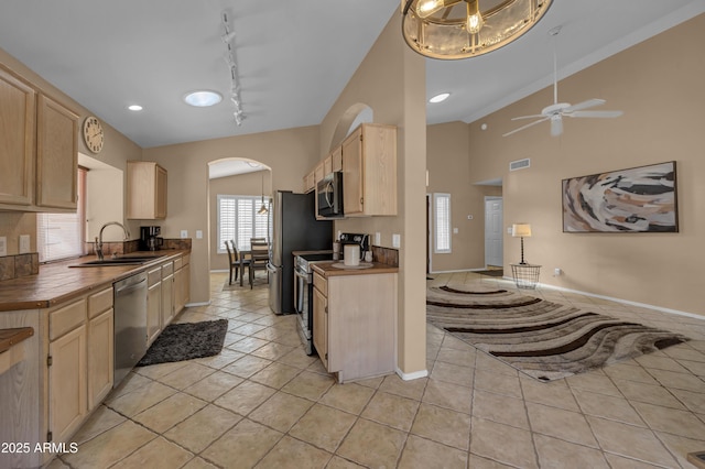 kitchen featuring ceiling fan, light brown cabinets, rail lighting, stainless steel appliances, and sink