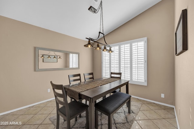 tiled dining area featuring lofted ceiling and a notable chandelier