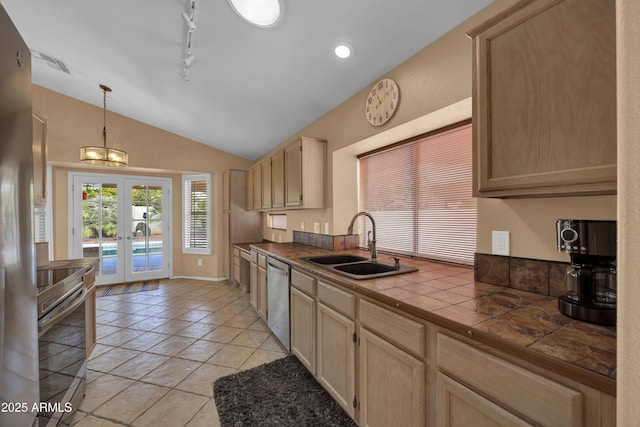 kitchen with french doors, stainless steel appliances, sink, light brown cabinets, and tile counters