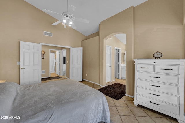 tiled bedroom featuring connected bathroom, high vaulted ceiling, and ceiling fan