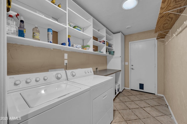 washroom featuring light tile patterned floors and washer and dryer