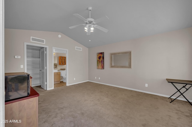 unfurnished living room with light carpet, vaulted ceiling, and ceiling fan