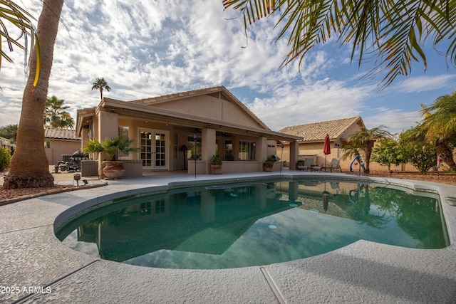 view of pool featuring french doors and a patio