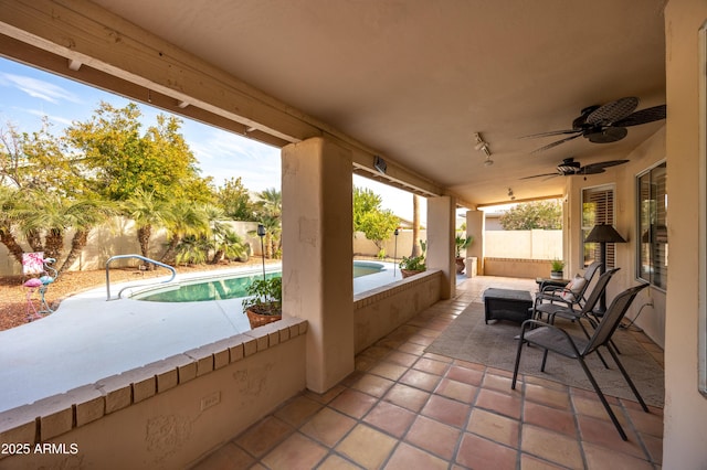 view of patio with a fenced in pool and ceiling fan