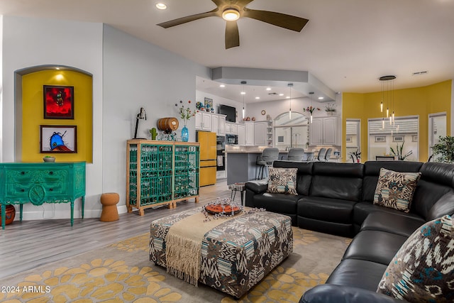 living room with light hardwood / wood-style floors and ceiling fan