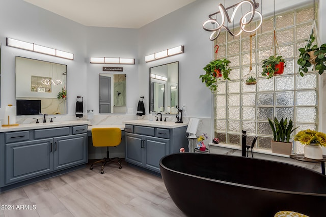 bathroom featuring a wealth of natural light, hardwood / wood-style floors, and vanity