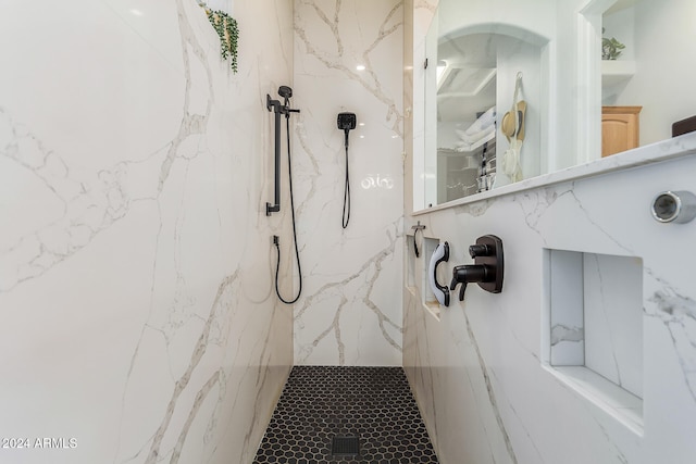 bathroom with tiled shower