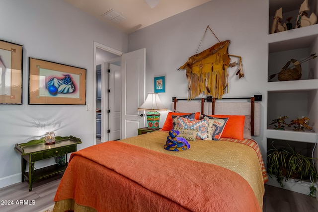 bedroom with hardwood / wood-style floors