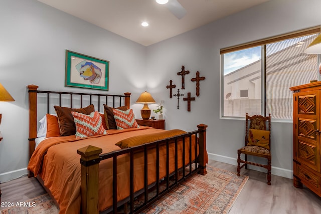 bedroom with wood-type flooring and ceiling fan