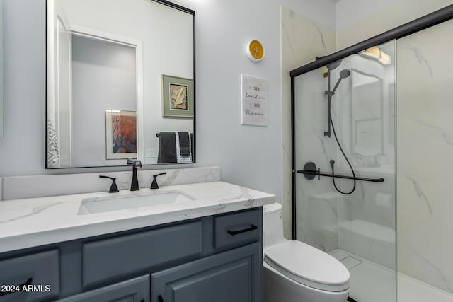 bathroom with vanity, toilet, and an enclosed shower