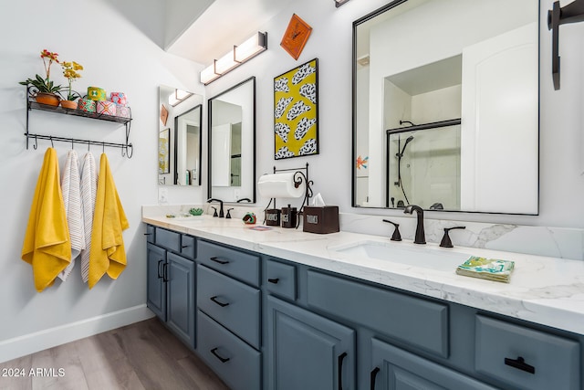 bathroom featuring hardwood / wood-style floors, vanity, and an enclosed shower