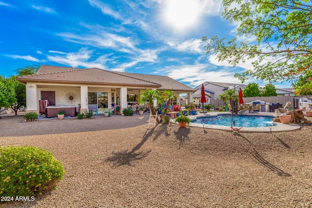 view of pool featuring pool water feature, a patio area, and a jacuzzi