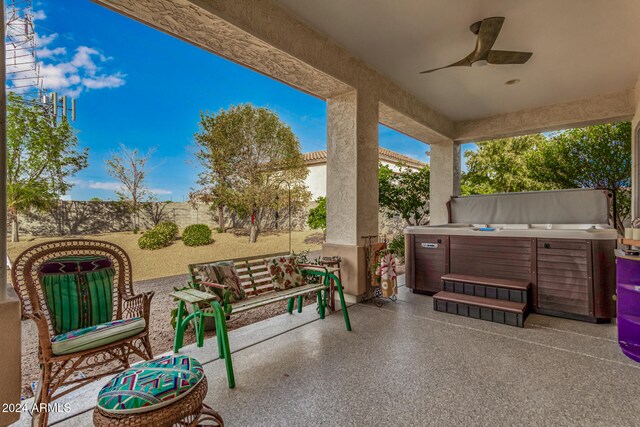 view of patio featuring ceiling fan and a hot tub