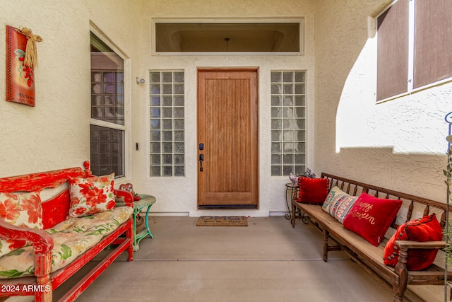 view of exterior entry featuring covered porch