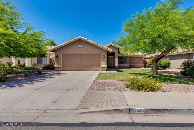 7346 E Naranja Ave, Mesa, AZ 85209 - ranch-style house featuring stucco siding, an attached garage, a tile roof, driveway, and a front lawn
