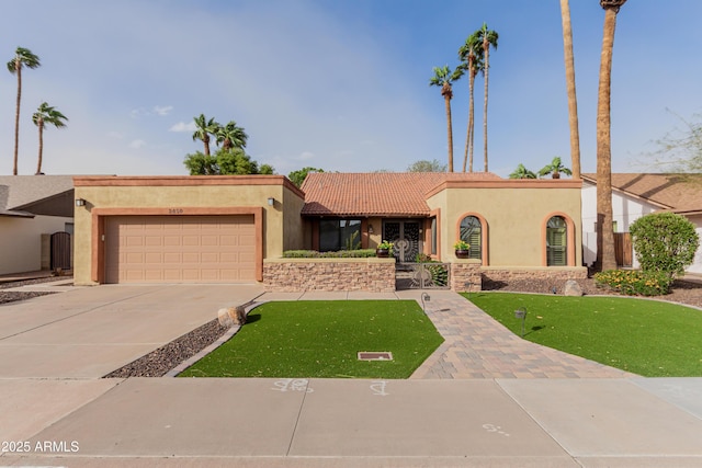 view of front of property with stucco siding, a tiled roof, concrete driveway, and a garage