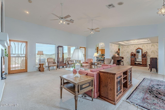 16507 E Trevino Dr, Fountain Hills, AZ 85268 - living room featuring light tile patterned floors, high vaulted ceiling, ceiling fan, visible vents, and light carpet