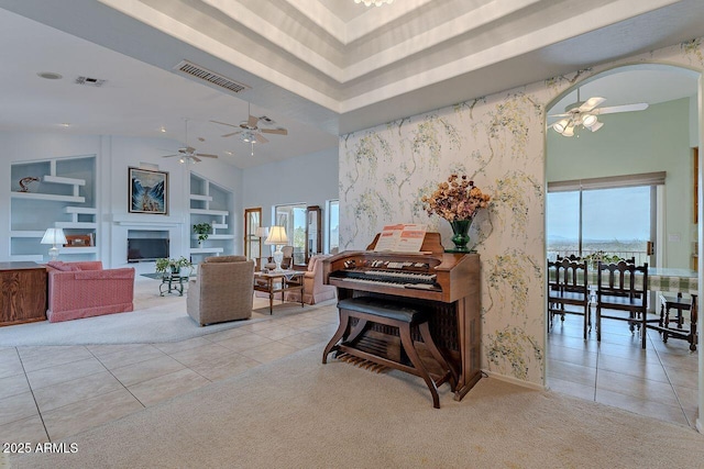 16507 E Trevino Dr, Fountain Hills, AZ 85268 - living room with built in shelves, visible vents, wallpapered walls, and a ceiling fan