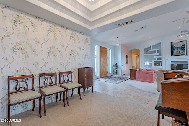 16507 E Trevino Dr, Fountain Hills, AZ 85268 - living area with visible vents, ceiling fan, light carpet, arched walkways, and light tile patterned floors