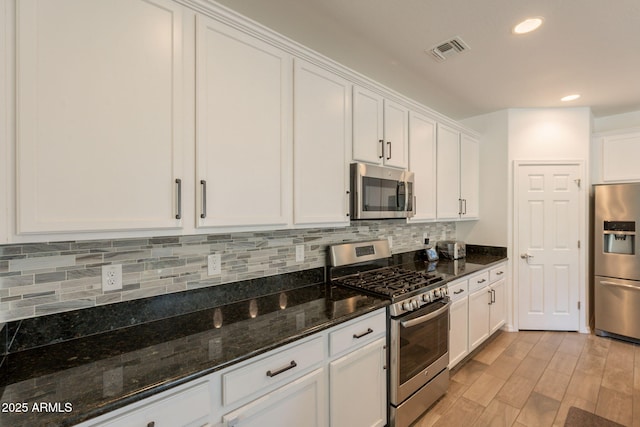 kitchen featuring visible vents, appliances with stainless steel finishes, light wood-style floors, recessed lighting, and white cabinetry