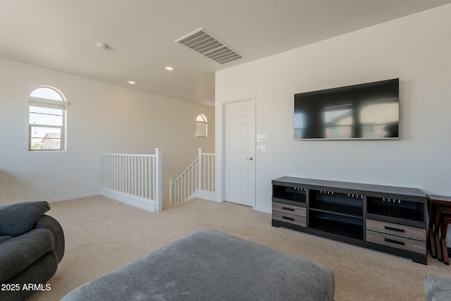 carpeted living room with recessed lighting and visible vents