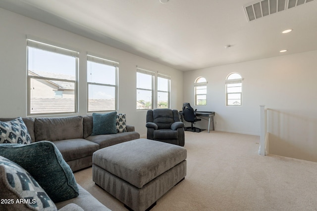 living room with visible vents, recessed lighting, baseboards, and light colored carpet