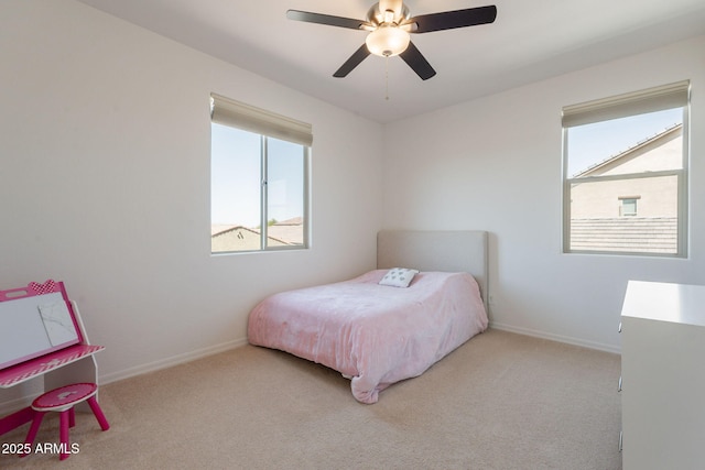 carpeted bedroom with baseboards and ceiling fan
