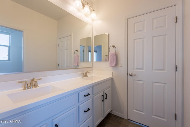 full bathroom with double vanity and a sink
