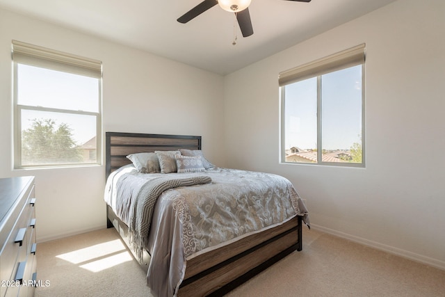 bedroom with baseboards, multiple windows, and carpet flooring