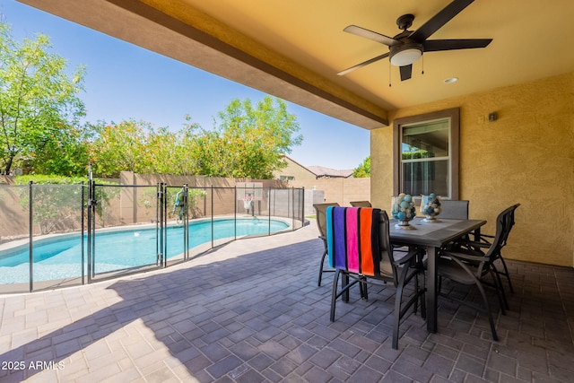 view of pool with ceiling fan, outdoor dining area, fence, a fenced in pool, and a patio