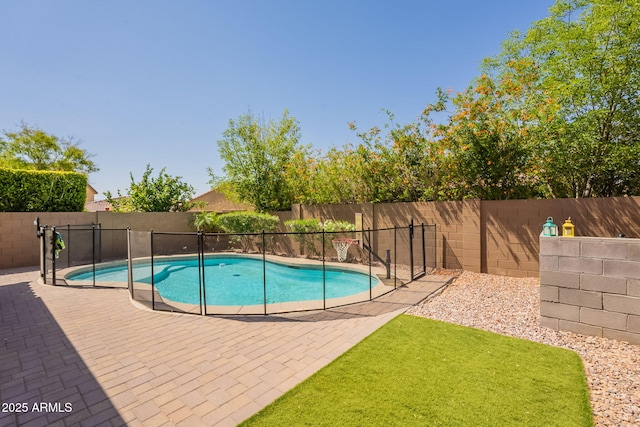 view of swimming pool with a fenced in pool, a fenced backyard, and a patio