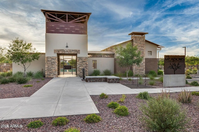 exterior space with stone siding and stucco siding