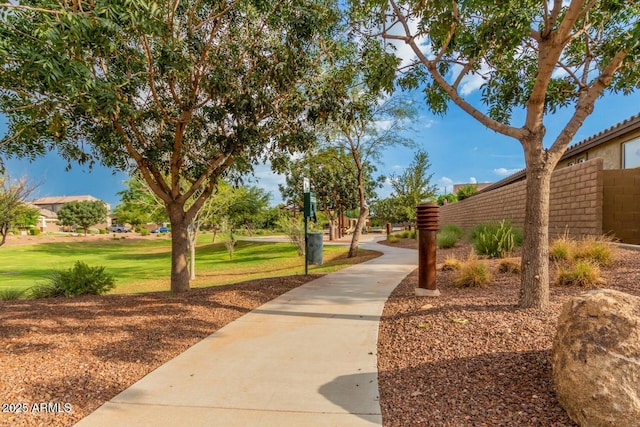 view of community with fence and a yard