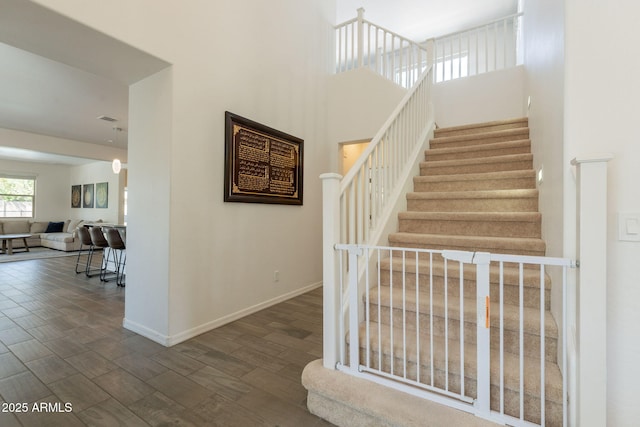 stairs featuring baseboards and wood finished floors