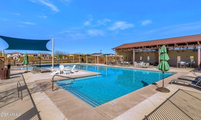 pool with a patio and fence