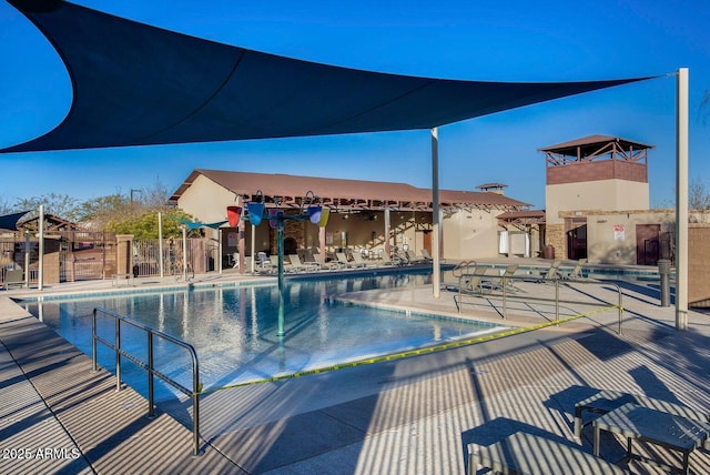 community pool featuring a patio and fence
