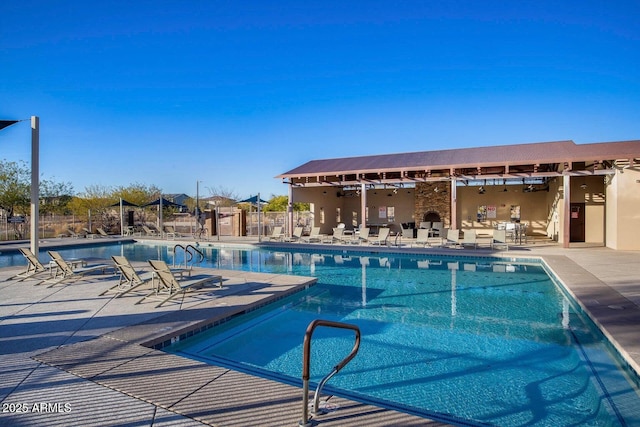 pool featuring fence and a patio area