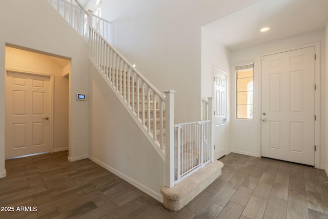 entrance foyer featuring baseboards, recessed lighting, wood finished floors, and stairway