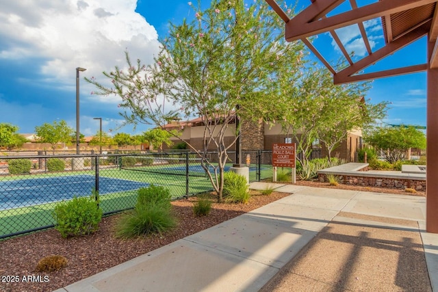 view of sport court with fence