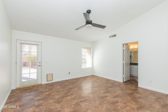 spare room featuring lofted ceiling, ceiling fan, visible vents, and baseboards