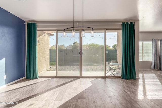 entryway with hardwood / wood-style floors and a chandelier