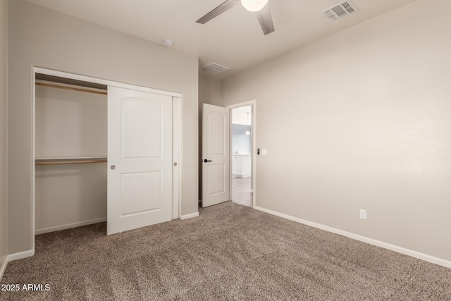 unfurnished bedroom with carpet, a closet, and ceiling fan