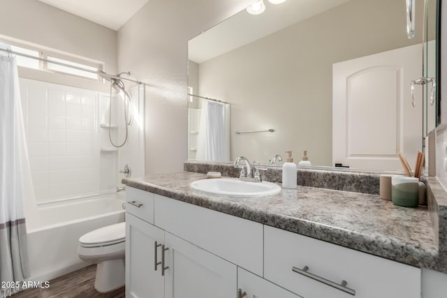 full bathroom featuring hardwood / wood-style floors, vanity, toilet, and shower / bathtub combination with curtain